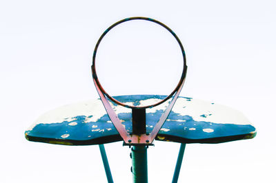 Low angle view of basketball hoop against white background