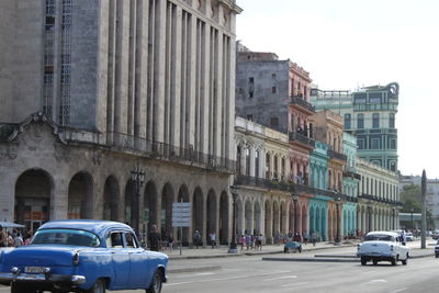 Cars in city against sky