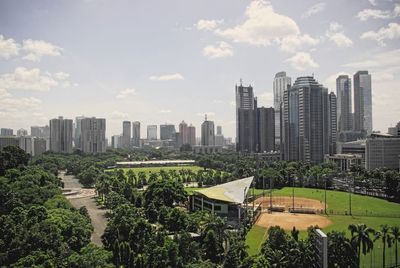 View of cityscape against cloudy sky