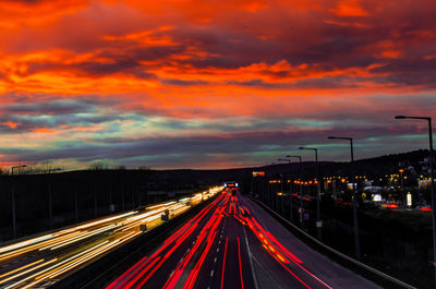 Light trails on highway at sunset