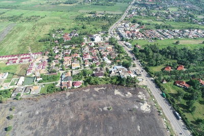 High angle view of agricultural field by building