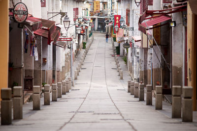 Empty alley amidst buildings in city