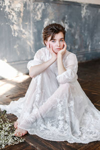 Portrait of young woman sitting indoors