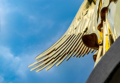 Low angle view of cross against blue sky