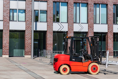 Forklift at a construction site against the backdrop of a large building. side view.
