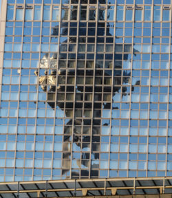 Low angle view of glass building against sky