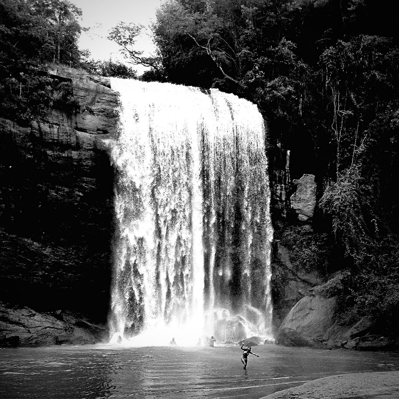 water, motion, splashing, tree, fountain, long exposure, full length, lifestyles, spraying, leisure activity, waterfall, flowing water, men, nature, blurred motion, waterfront, outdoors, day