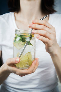 Midsection of woman holding drink