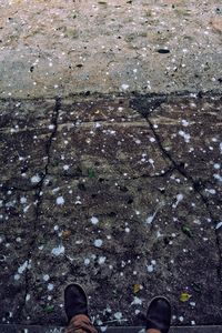 Low section of man standing on puddle