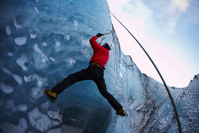 Man climbing at solheimajokull glacier in iceland