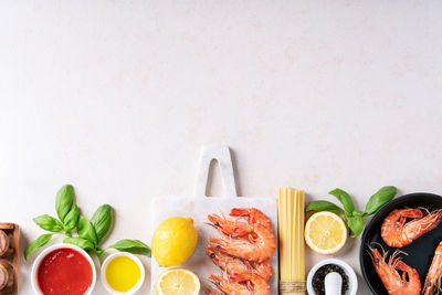 Directly above shot of fish on table against white background