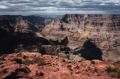 Scenic view of canyon against storm clouds