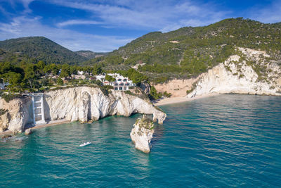 Scenic view of sea and mountains against sky