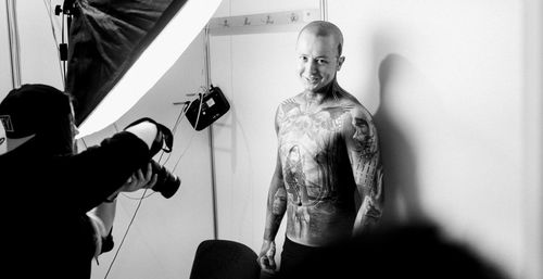 Portrait of shirtless man standing at home