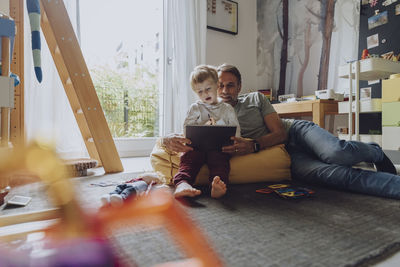 Rear view of people sitting at home