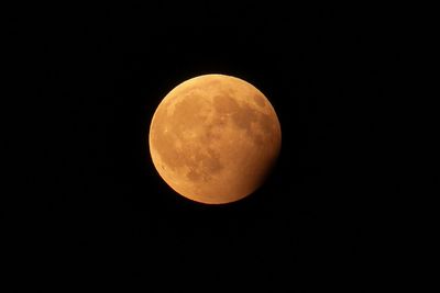 Low angle view of moon against clear sky at night