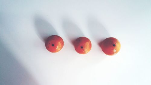 Close-up of red object over white background