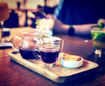 Tea cup and coffee on table at cafe