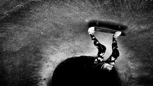 High angle view of man holding umbrella on street