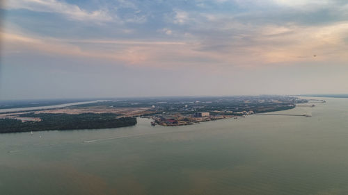 Aerial view of sea and cityscape against sky