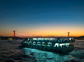 Bridge over sea against sky during sunset