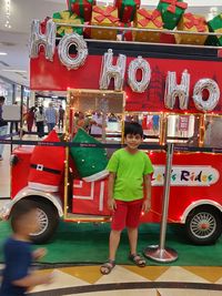 Full length of boy standing on bus