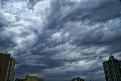 Low angle view of building against cloudy sky