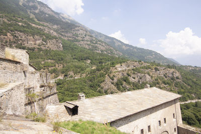 Houses on mountain against sky