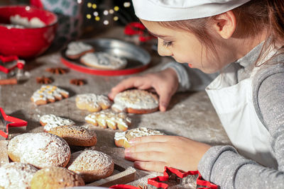 A girl enjoys christmas cookies. merry christmas and happy holidays.