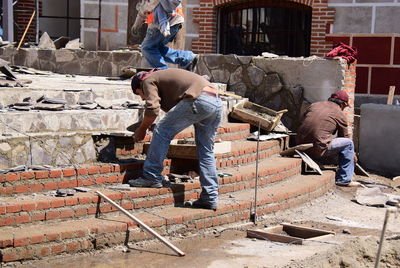 Rear view of worker working at construction site