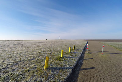 Wooden posts on beach against clear sky