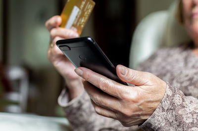 Midsection of man using mobile phone