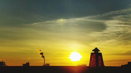 Low angle view of silhouette building against sky during sunset