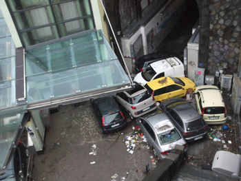 High angle view of cars on street by buildings