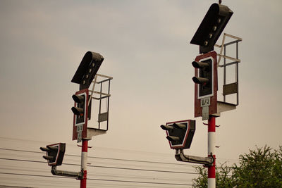 Low angle view of cranes against sky