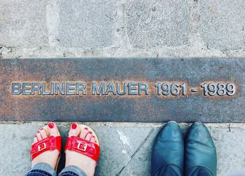 Two women standing on the berlin wall