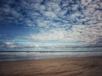 Scenic view of sea against cloudy sky