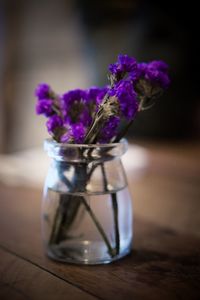 Close-up of purple flower in vase on table