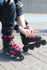 Low section of woman wearing roller skates