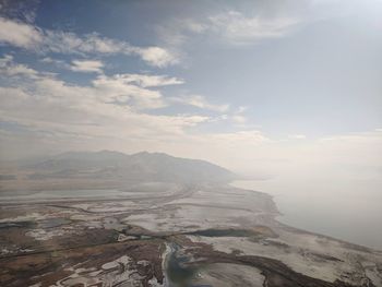 Scenic view of salt flats and  mountains against sky