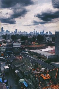 Cityscape against cloudy sky