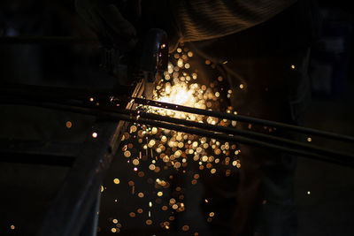 Cropped hand of person using grinder in factory