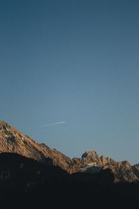 Low angle view of mountains against clear blue sky