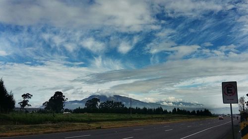 Road by landscape against sky