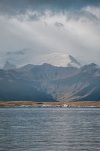 Scenic view of lake and mountains against sky