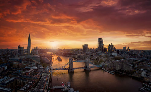 Aerial view of buildings in city during sunset