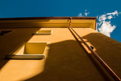 Low angle view of yellow building against sky