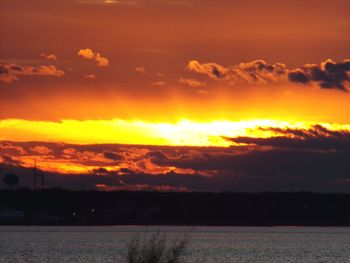 Scenic view of dramatic sky over sea during sunset