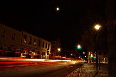 Illuminated road in city at night