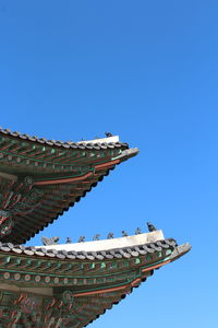 Low angle view of temple against clear blue sky